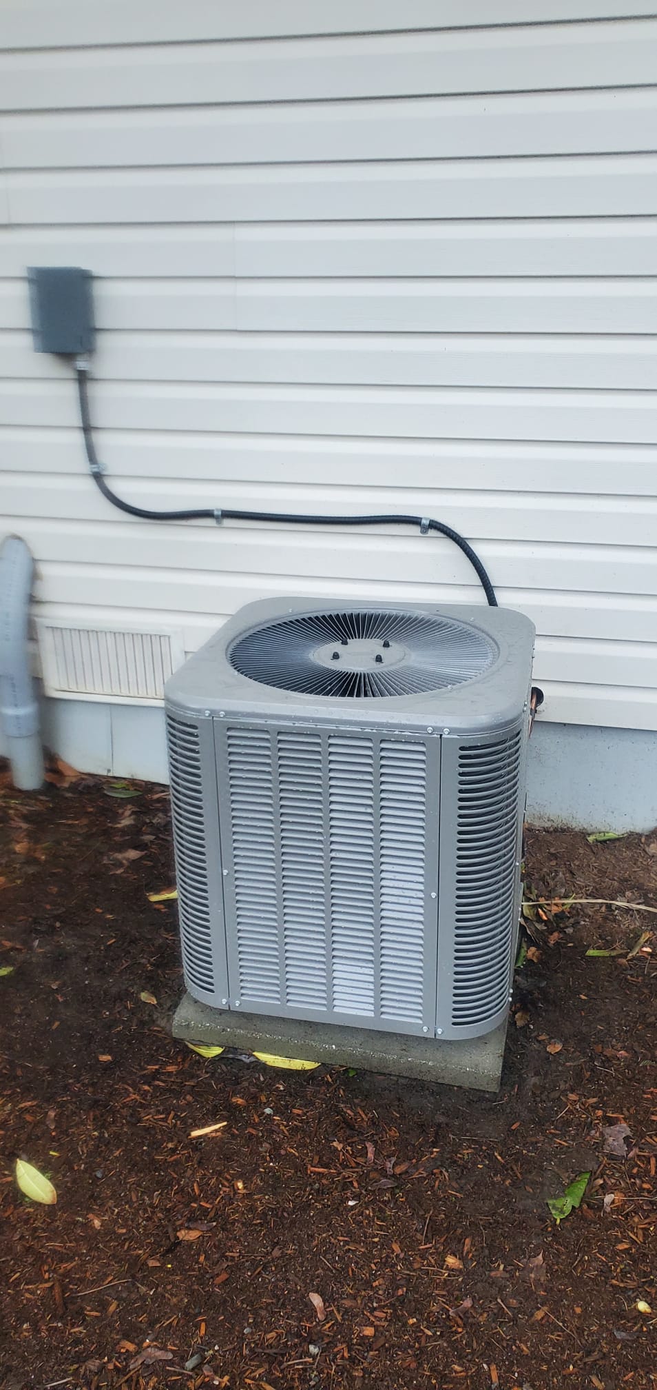Outdoor air-conditioning unit documented during a Chilliwack residential retrofit