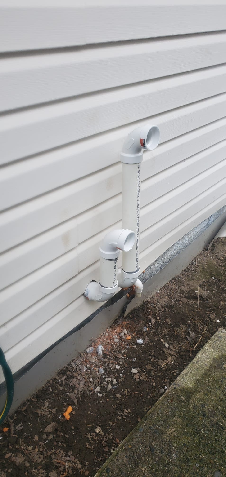 White sidewall vent terminals photographed during a Chilliwack HVAC retrofit